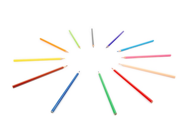 Round radius and circle arrangement by blunt colour pencils directed and pointed to the center of the wheel. It has copy space on the white background for any text insertion.