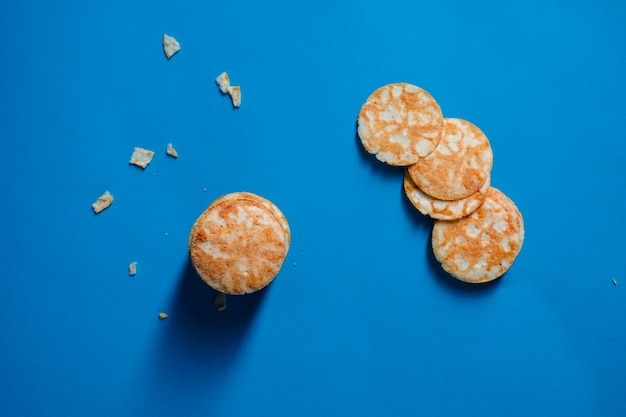 Photo round rice chips on a blue paper background