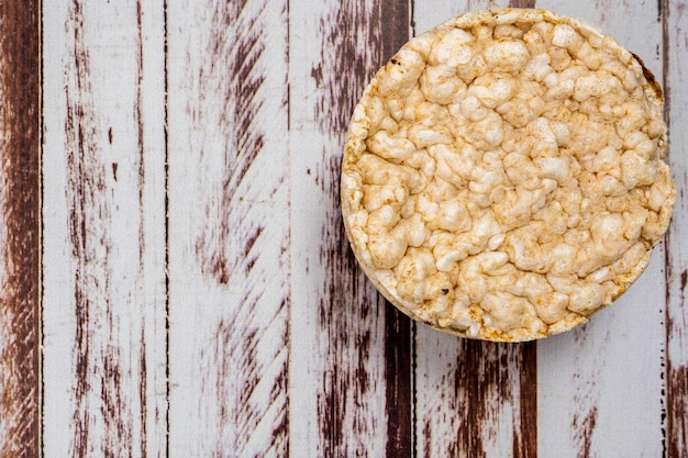 Round rice crackers on a rustic wooden table Copy space Healthy natural food Vegan food