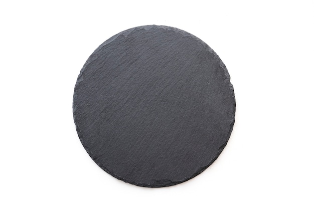 Round slate plate, black slate board isolated on white. Top view