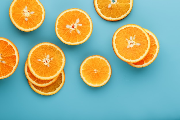 Round slices of juicy orange on blue