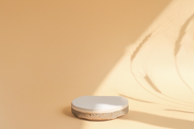 A round stone stage on a beige background with a central position in the composition