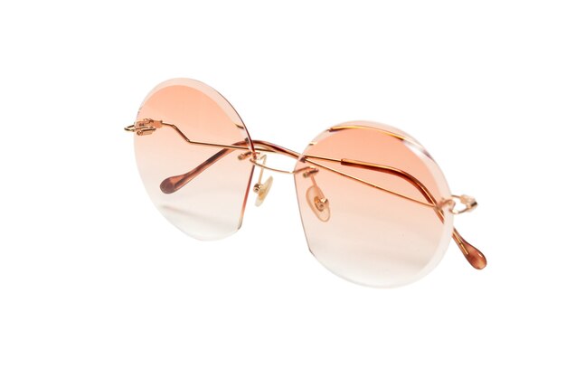 Round summer woman sunglasses isolated on a white surface.