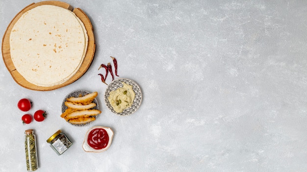 Photo round tortilla with dips next to roasted chicken