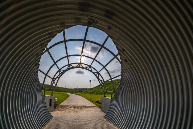 Round tunnel footpath on blue sky background