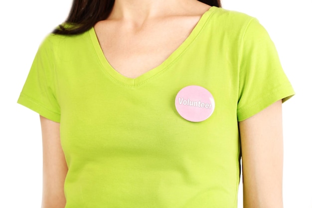 round volunteer button on shirt of girl isolated on white