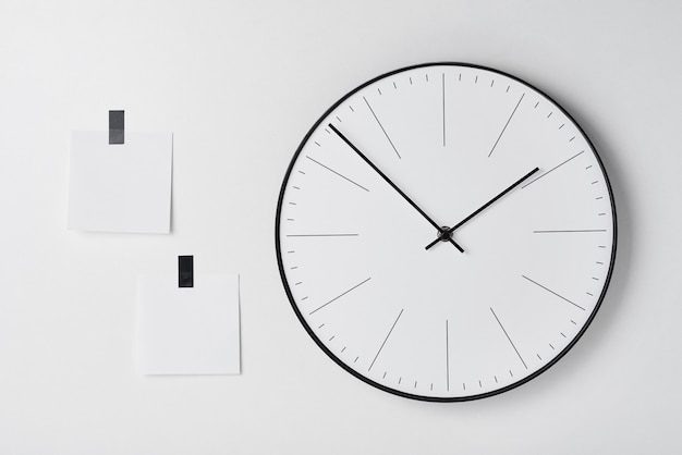 Round wall clock and sticky on white