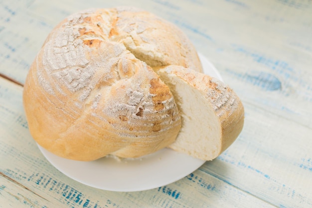 Round white bread on a wooden background