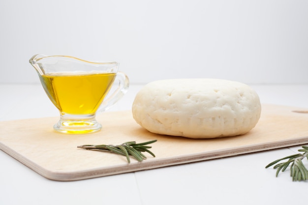 Round white cheese with rosemary and olive oil