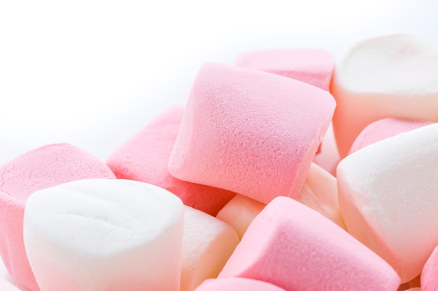 Round white and pink marshmallows on a white backgrouns.