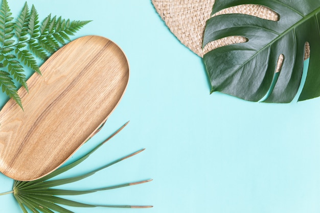 Photo round wicker stand and palm leaves.