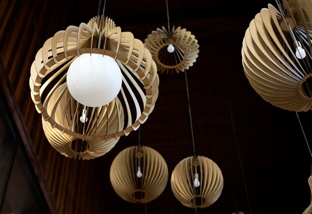 Round wood chandeliers with large lamps