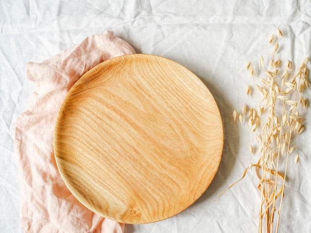 Round wooden craft tray and dry oat ears