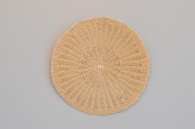 Round woven placemat isolated on a grey background