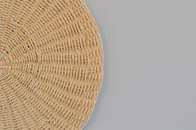 Round woven placemat isolated on a grey background