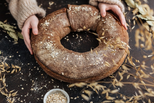 Round yeast-free bread in children's hands.