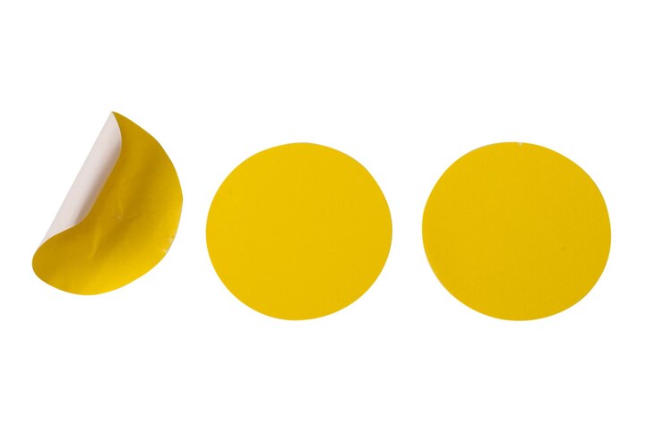 Photo round yellow stickers blank tags labels isolated on a white background top view