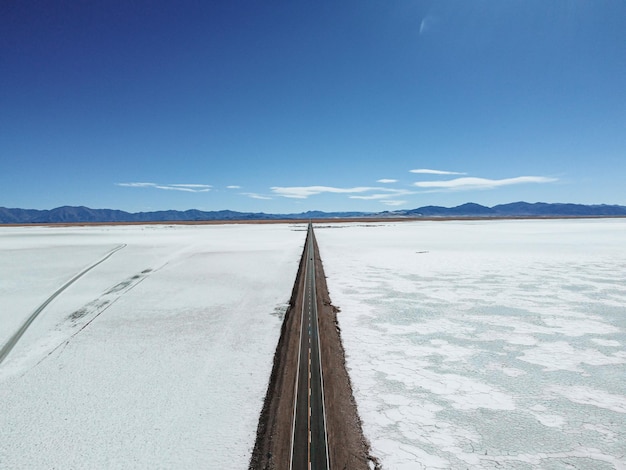 Route on a middle of salina with a blue sky