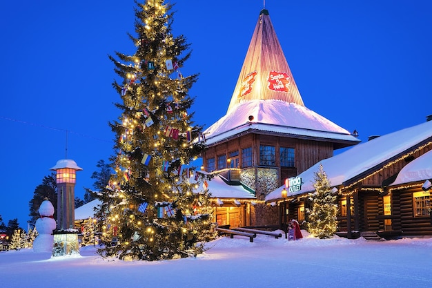 Rovaniemi, Finland - March 5, 2017: Santa Claus Office at Santa Village with Christmas trees in Lapland, Finland, Scandinavia, on Arctic Circle in winter. At night