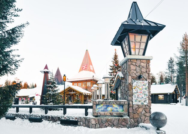 Rovaniemi, Finland - March 5, 2017: Santa Claus Office in Santa Village with Christmas trees at Lapland of Finland. Scandinavia, on Arctic Circle in winter. People on the background