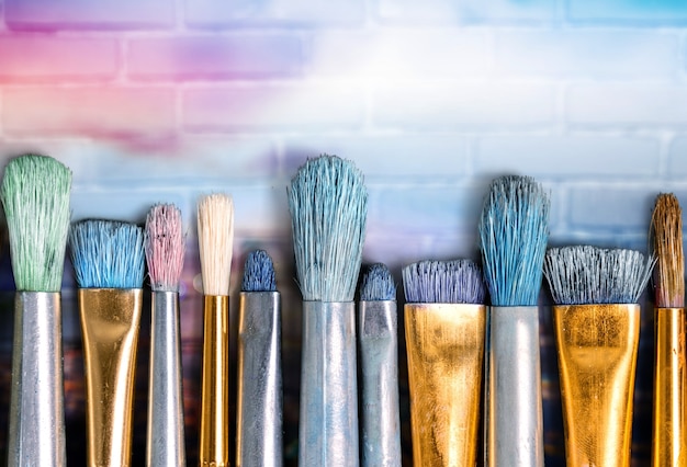 Row of artist paint brushes  on background