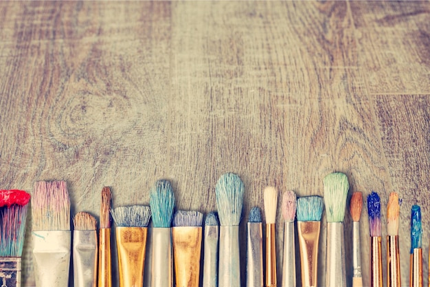 Row of artist paint brushes  on background