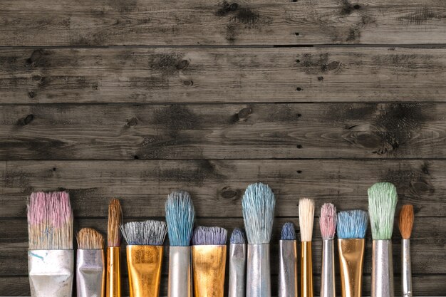 Row of artist paint brushes  on background