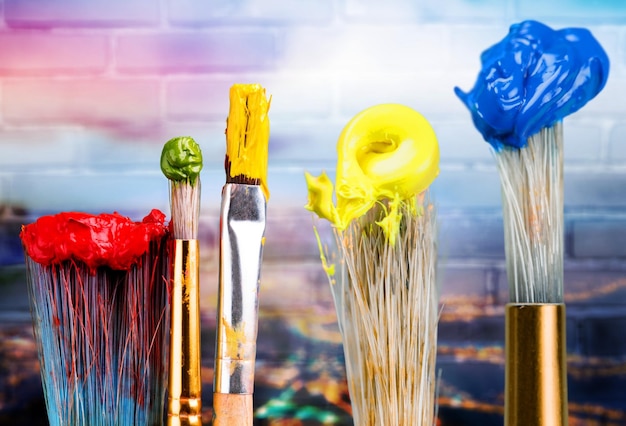 Photo row of artist paint brushes on background