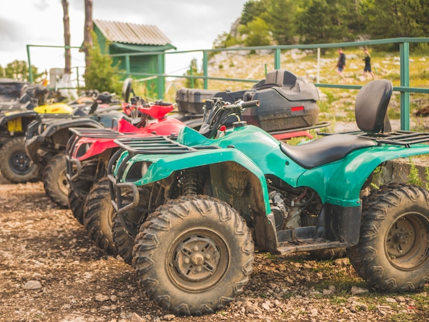 Row of atv power bikes on a summer day on a mountain parking zone