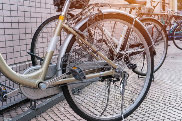 Row of bicycle japan style classic with seats at sidewalk\
parking in tokyo, japan