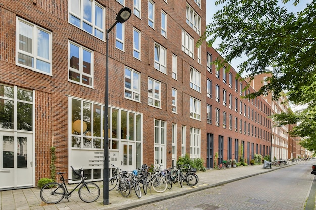 A row of bikes parked outside of a brick building