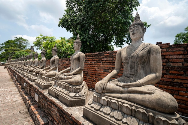 The Row of Buddha statues Beautiful Bhudda Image in front of Main Stupa Chedi of Wat Yai Chai Mongkhon Temple Ayutthaya Archaeological site Thailand