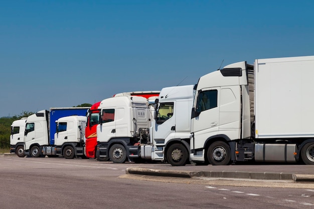 Row of cab over semitrailer trucks