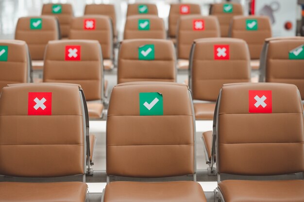 Row of chair with social distance sign to prevent spreading of virus during coronavirus outbreak