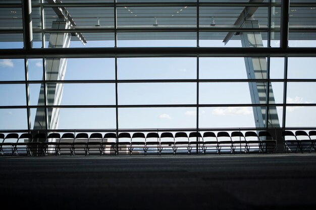 Photo row of chairs silhouetted against a window in a conference centre