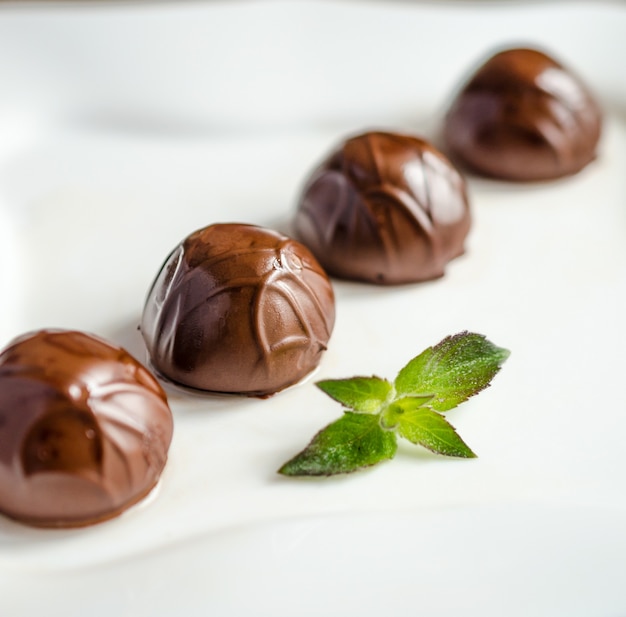 A row of chocolate candies with mint