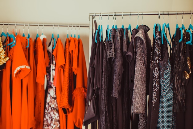 Row of clothes hanging on rack in store