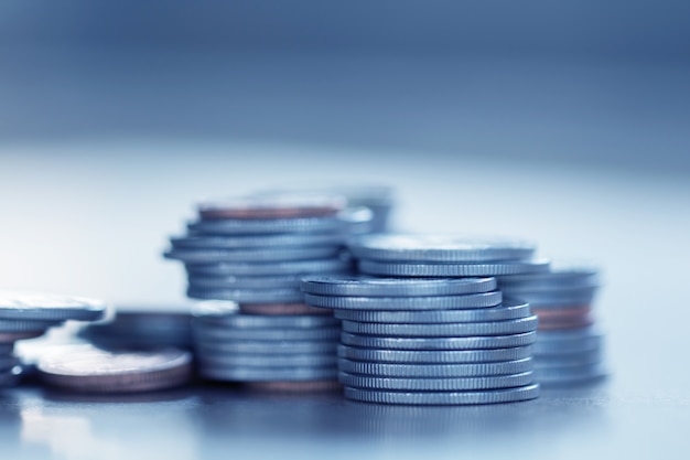 Row of coins on wood background for finance and Saving concept