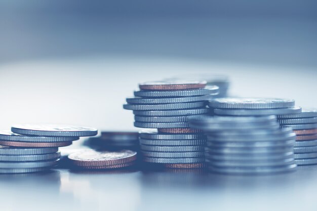 Row of coins on wood background for finance and Saving concept