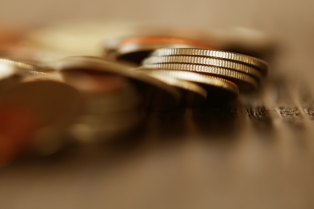 Row of coins on wood background for finance