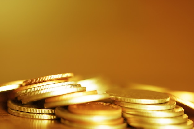 Row of coins on wood background