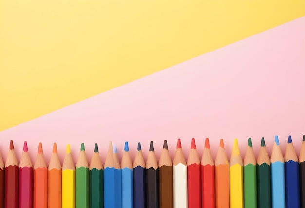 a row of colored pencils with a yellow background