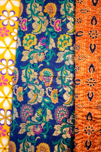 A row of colorful fabric with a floral pattern on the bottom.