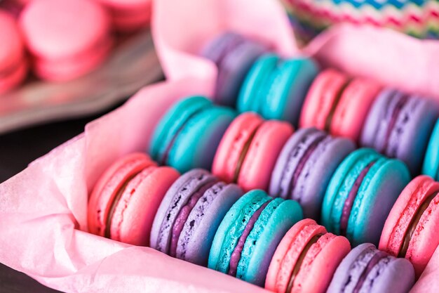 Row of colorful french macaroons in the box.