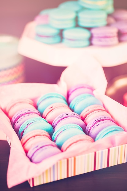 Row of colorful french macaroons in the box.