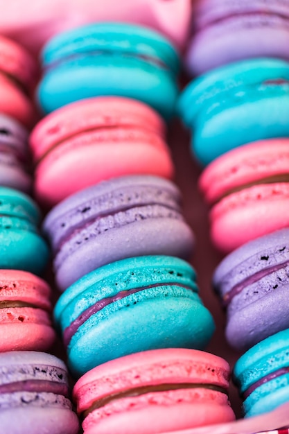 Row of colorful french macaroons in the box.