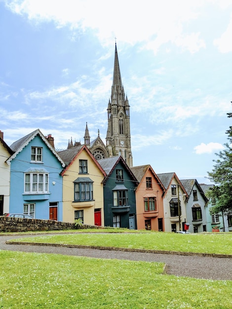 a row of colorful houses with a church in the background