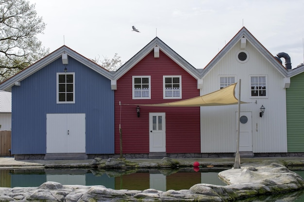 A row of colorful houses with a white door and a yellow awning.