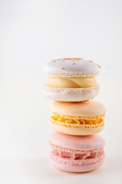 Row of colorful pastel french macaroons or macarons  on white background