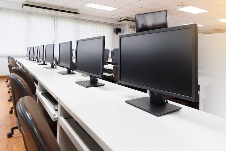 Photo row of computers on desks in classroom at general training center